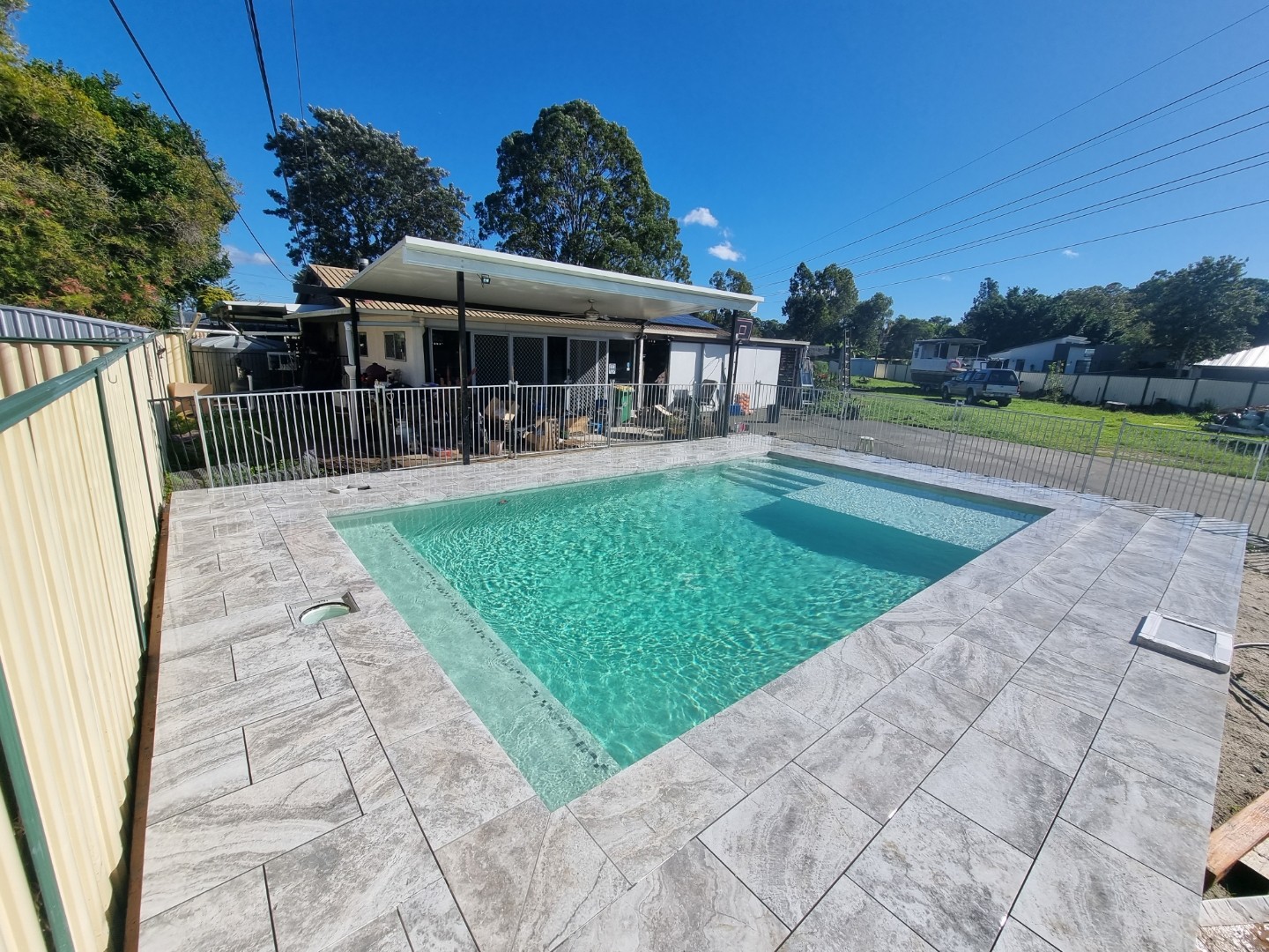 Completed pool tiling and tiled pool surround